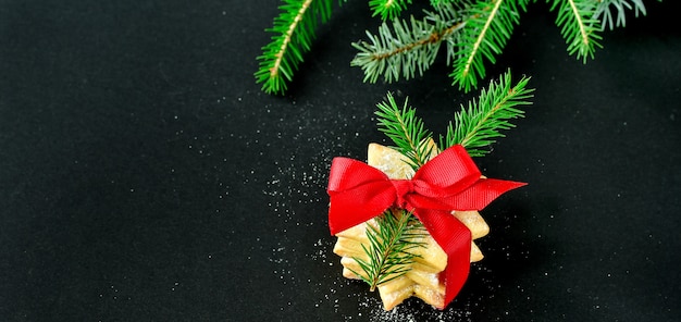 Gingerbread cookie decorated with a red ribbon with a bow