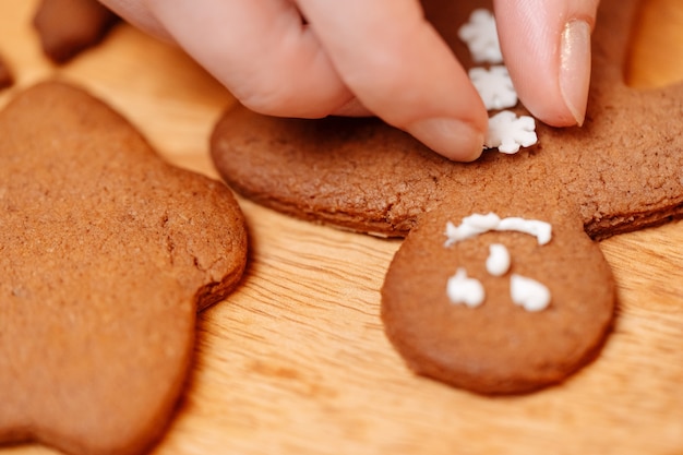 Gingerbread cookies are decorated with sweet icing snowflakes buttons sweet pastries for new year