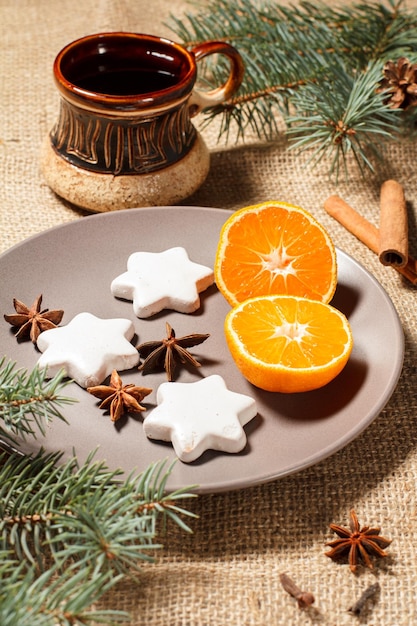 Gingerbread cookies in star shape on plate and cup of coffee