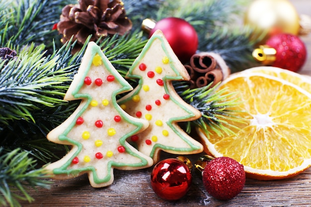 Gingerbread cookies with Christmas decoration on wooden table