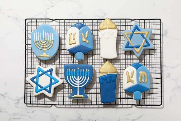 Gingerbread cookies with Jewish signs on marble background top view