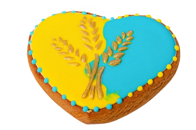 Gingerbread in the form of a heart in yellow and blue colors with ears of wheat Ukrainian style