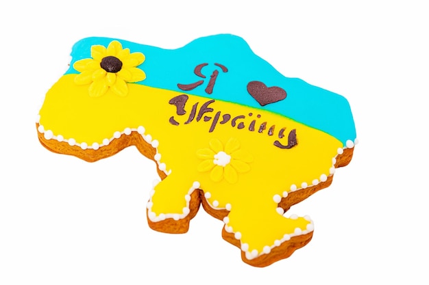 Gingerbread in the form of a map of Ukraine in yellow and blue colors with drawn hearts Ukrainian