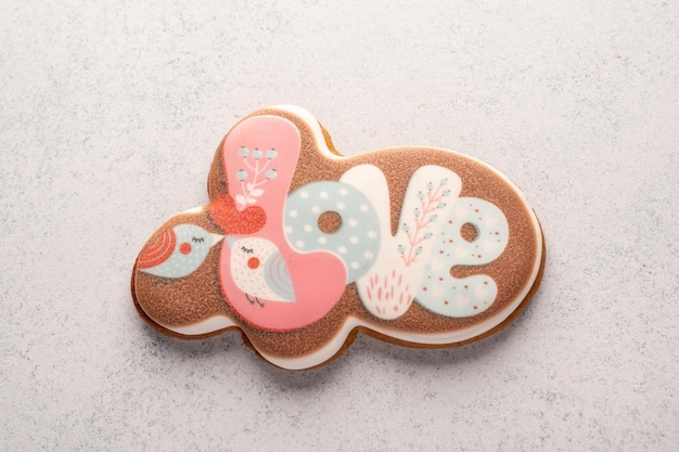 Gingerbread in glaze with the inscription love on gray backgrownd copy space