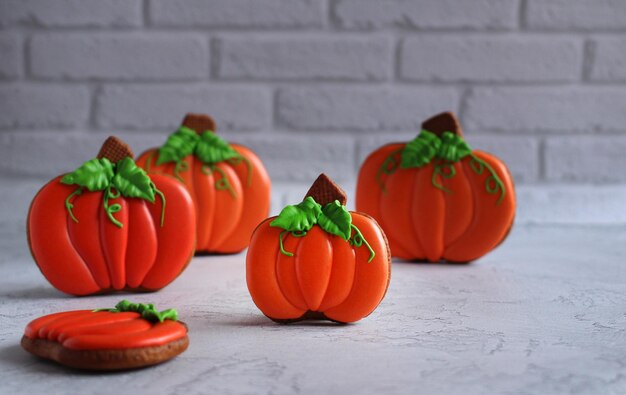 Gingerbread handpainted in the form of pumpkins on a light background