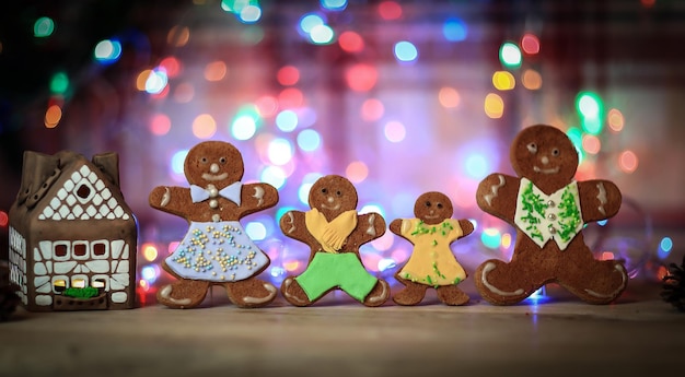 Gingerbread house and gingerbread men on a festive background