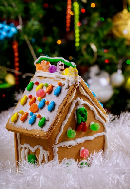 Gingerbread house with round candies and frosting