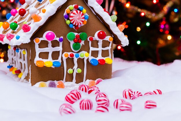 Photo gingerbread house with round  peppermint candies.