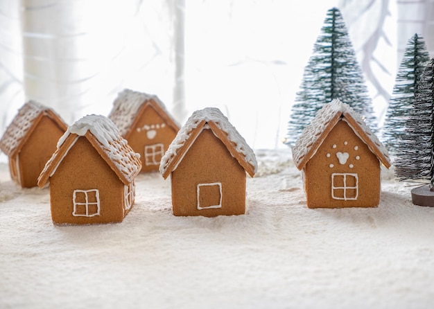 Gingerbread houses with a gnome a moose and a sleigh with gifts Black background for text