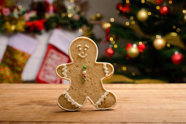 Gingerbread man cookie on wooden table with Christmas background Christmas dessert