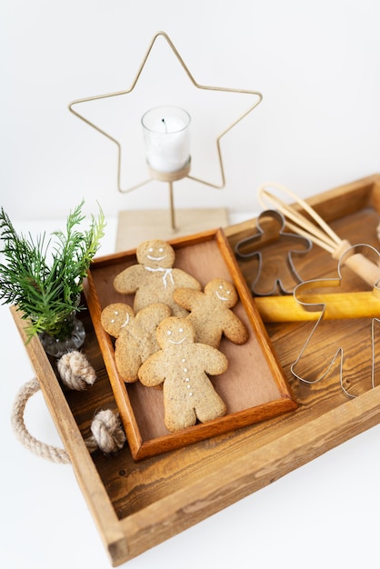 Gingerbread Man Cooking gingerbread at home lies on a wooden tray Holiday concept