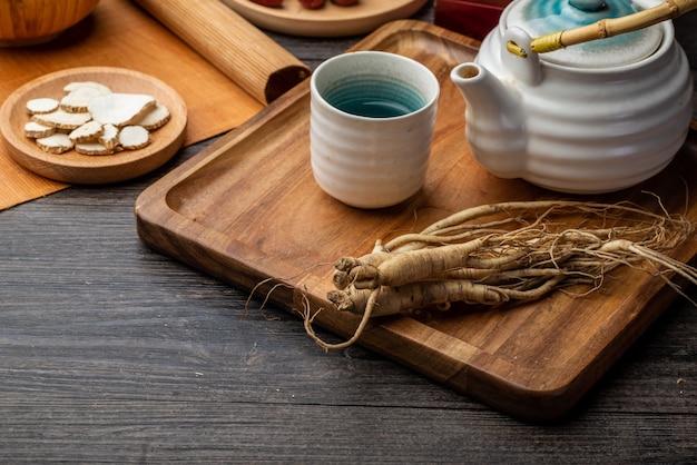 Ginseng and tea cup are on the table