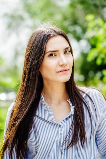 A girl of Asian appearance in a city park Summer portrait