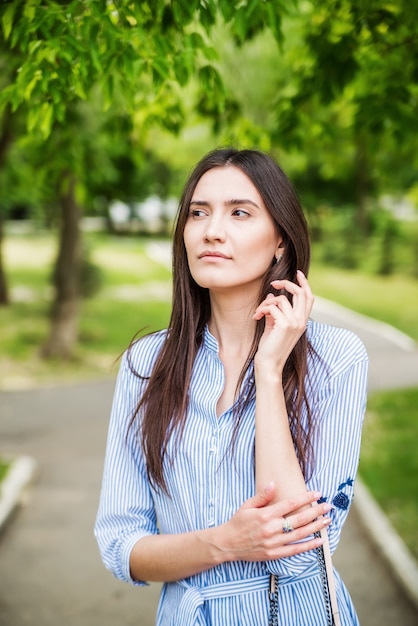 A girl of Asian appearance on a walk in a city park Summer portrait of young Tatar