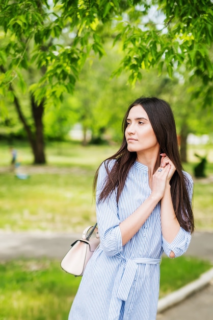 Girl of Asian appearance on walk in city park Summer portrait