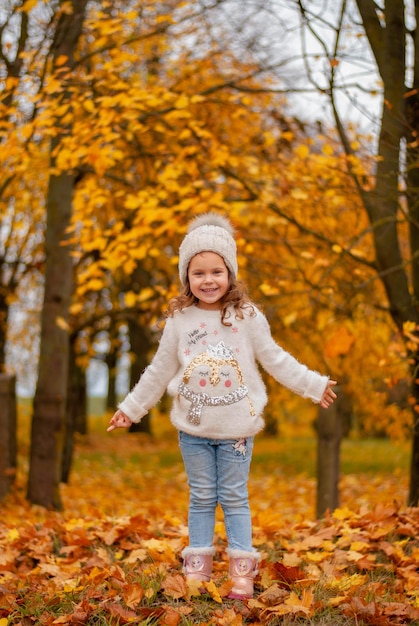 a girl in the autumn garden. autumn leaves. yellow trees.