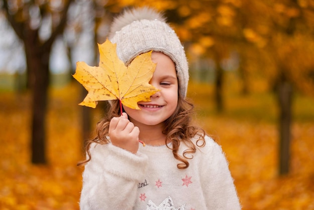 a girl in the autumn garden. autumn leaves. yellow trees.