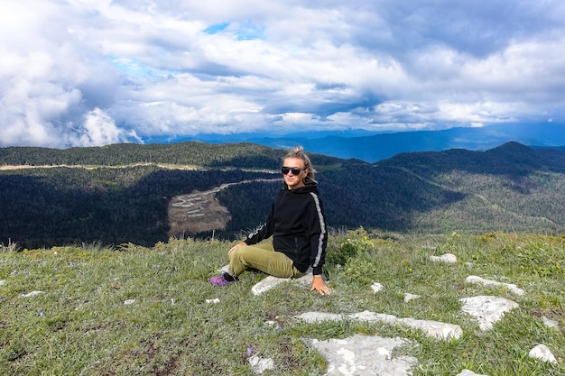 A girl on the background of alpine meadows of the LagoNaki plateau in Adygea Russia 2021