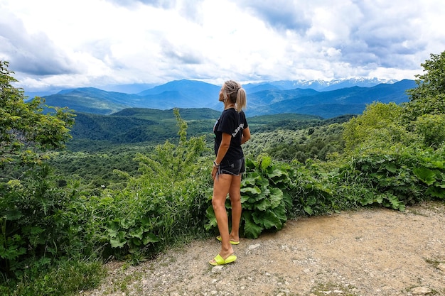 A girl on the background of alpine meadows of the LagoNaki plateau in Adygea Russia 2021