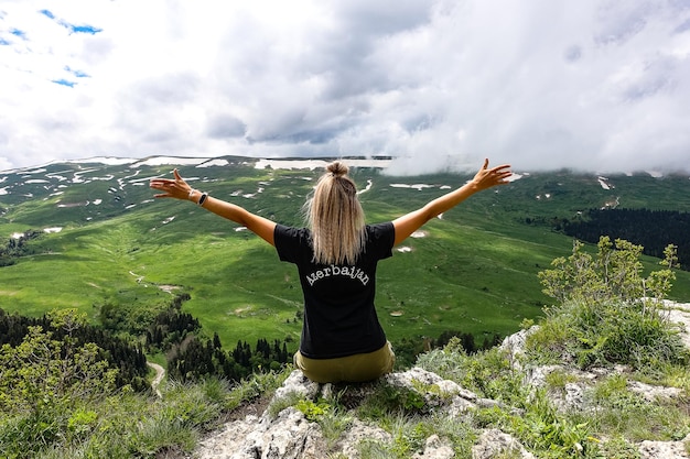 A girl on the background of alpine meadows of the LagoNaki plateau in Adygea Russia 2021