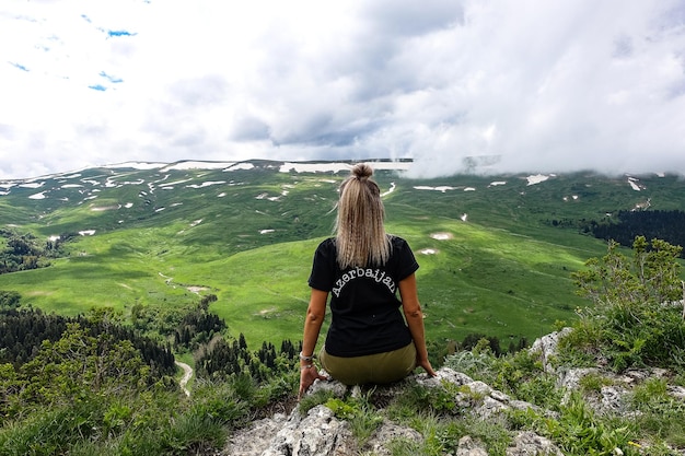 A girl on the background of alpine meadows of the LagoNaki plateau in Adygea Russia 2021