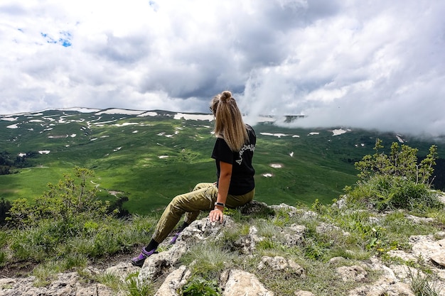 A girl on the background of alpine meadows of the LagoNaki plateau in Adygea Russia 2021