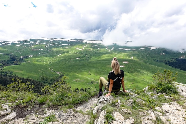 A girl on the background of alpine meadows of the LagoNaki plateau in Adygea Russia 2021