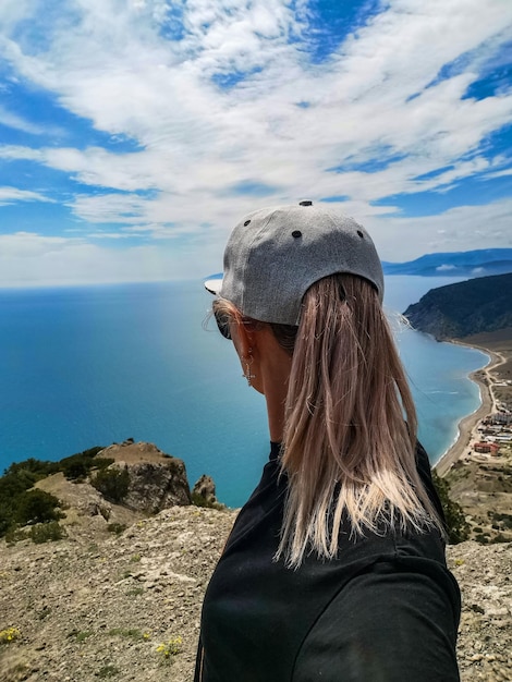 A girl on the background of the Black Sea and the Crimean mountains on the Golitsyn trail Crimea 2021