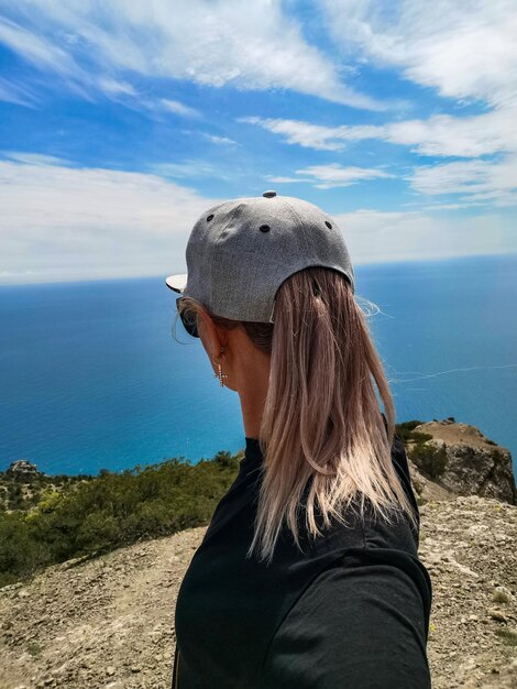 A girl on the background of the Black Sea and the mountains on the Golitsyn trail Crimea 2021