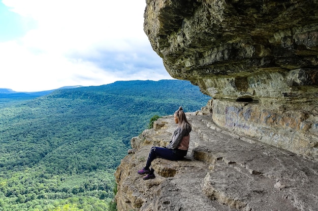 A girl on the background of the landscape of the Caucasus Mountains  The Eagle Rocks Mountain shelf Mezmai