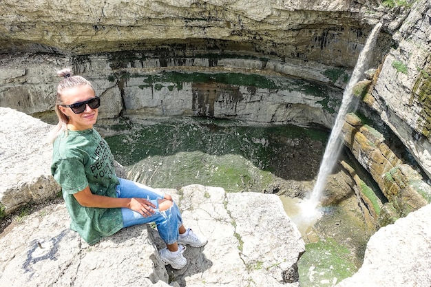 Girl on the background of Tobot waterfall Khunzakh waterfalls Dagestan Russia 2021