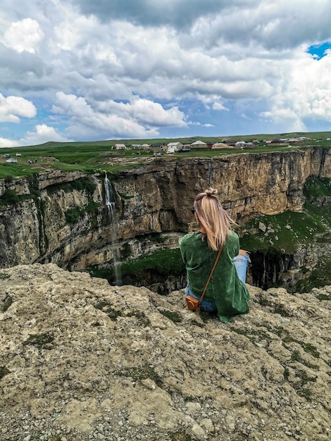 Girl on the background of Tobot waterfall Khunzakh waterfalls Dagestan Russia 2021