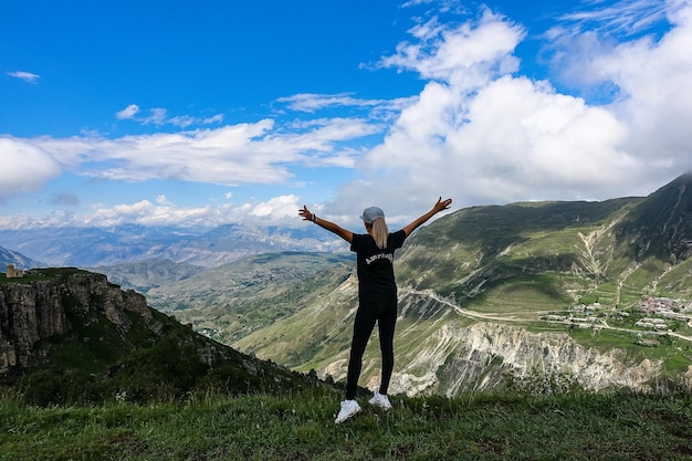 A girl on the background of a view of the Matlas plateau Khunzakhsky district Dagestan Russia 2021