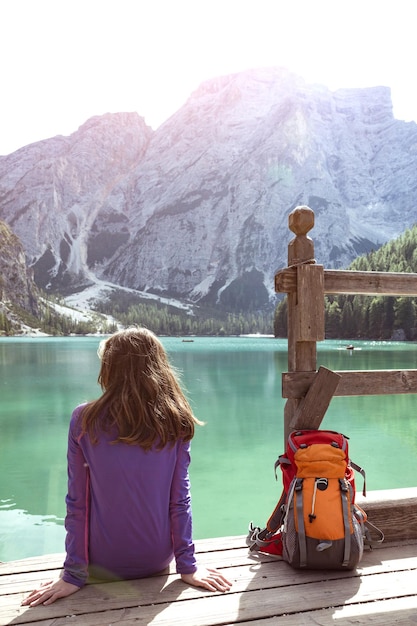 Girl backpacker looking at Braies lake