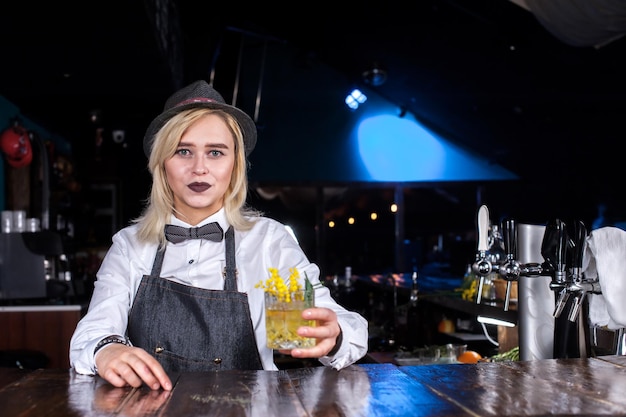 Girl bartender concocts a cocktail at the public house