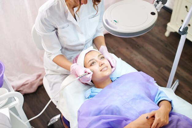 Girl beautician works with patients in the office