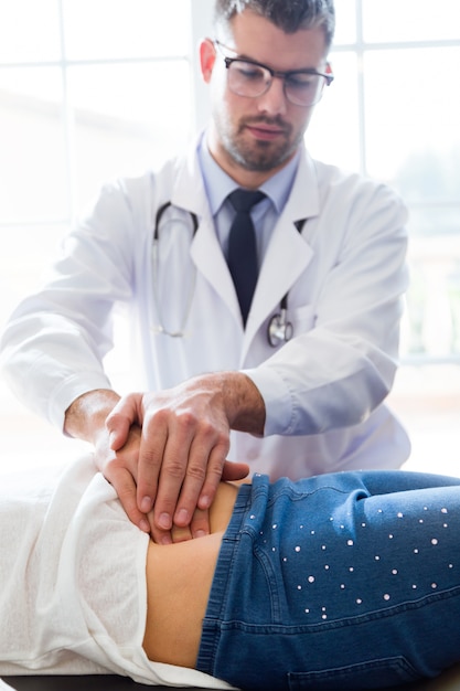 Girl being examined by pediatrician in the office.