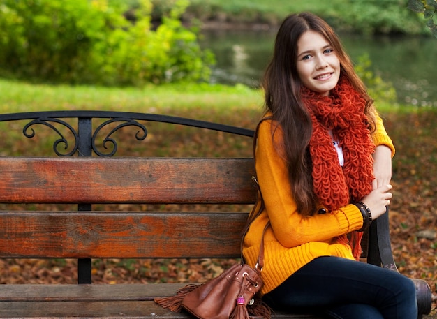 Girl on bench in autumn park