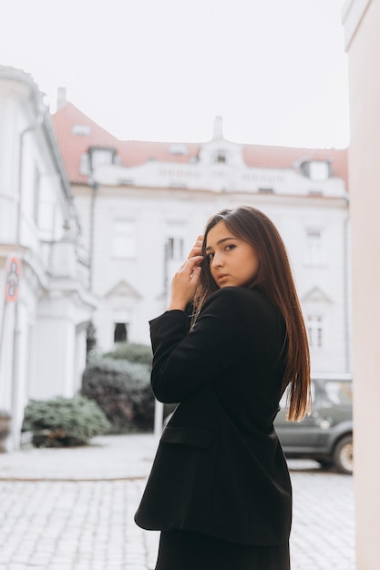 Girl in black dress walking in old city