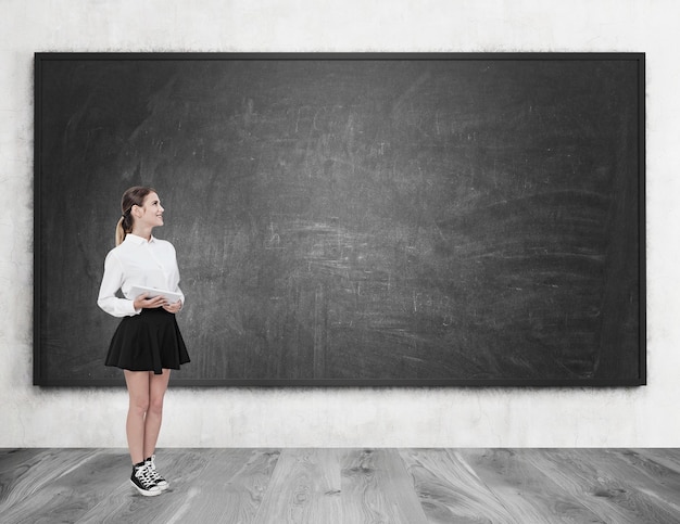 Girl in black skirt near chalkboard