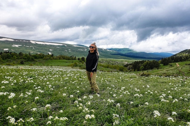 A girl on the blooming alpine meadows of LagoNaki Adygea Russia 2021