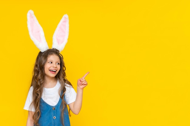 A girl in a blue dress with bunny ears on a yellow background