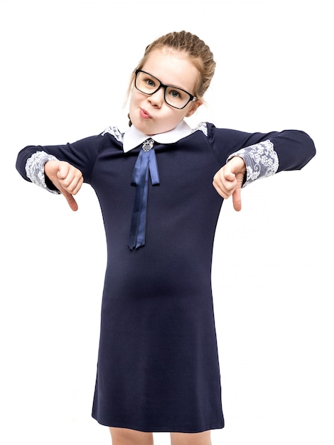 Girl in a blue school uniform emotionally posing on a white background