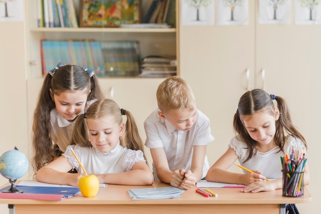 Girl and boy looking at friends studying