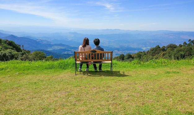 Girl and Boyfriend sitting on bench and see sky scape. felling Lover and Happy.