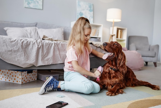 Girl Brushing Dog at Home