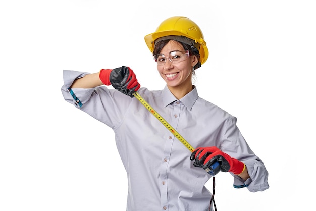 Girl builder with a ruler on a white background