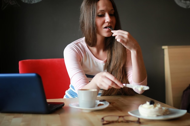 Girl in a cafe for a cup of coffee with the notebook