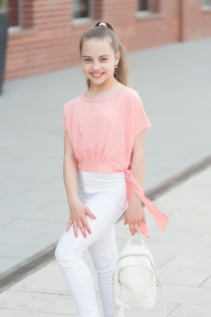 Girl carefree child. Happy day. Kid long hair enjoy walk sunny day. Summer holidays relax. Charming stylish fashionable girl. Little child enjoy walk. Summer is here. Summer vacation and tourism.