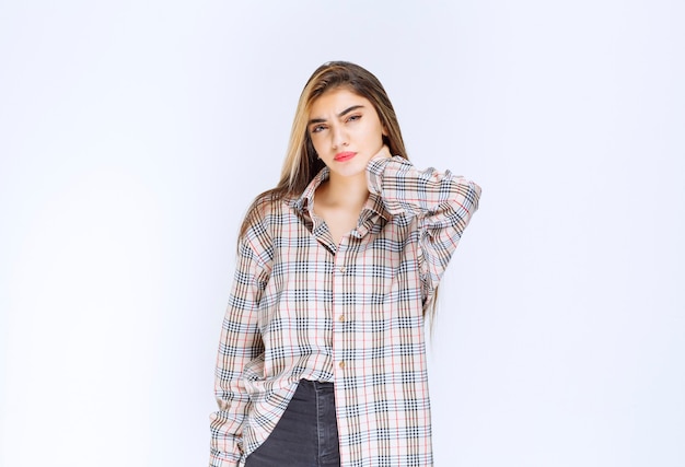 Girl in checked shirt looks pale and sleepy